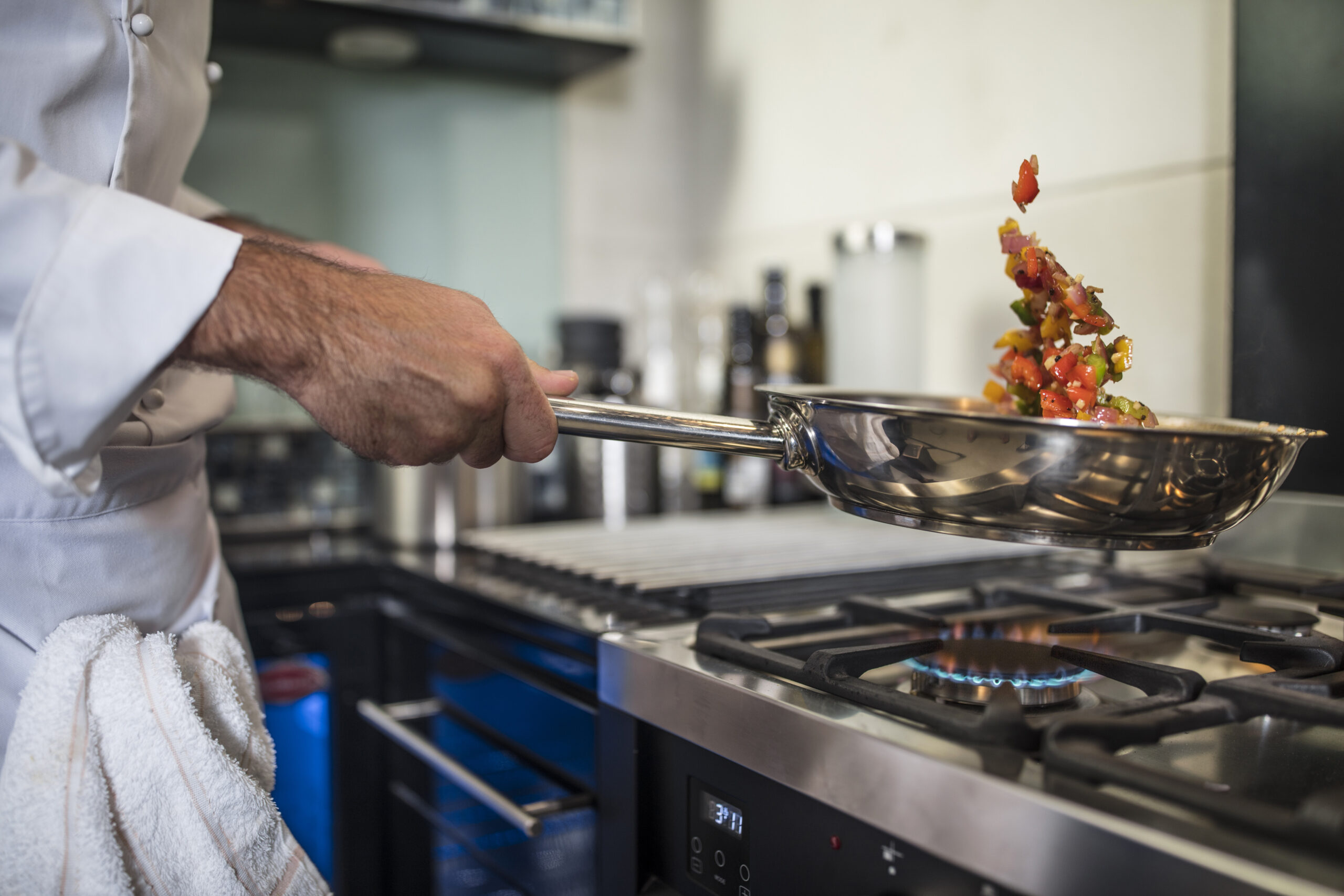 Commercial Pest Control Services: chef preparing food in a professional kitchen