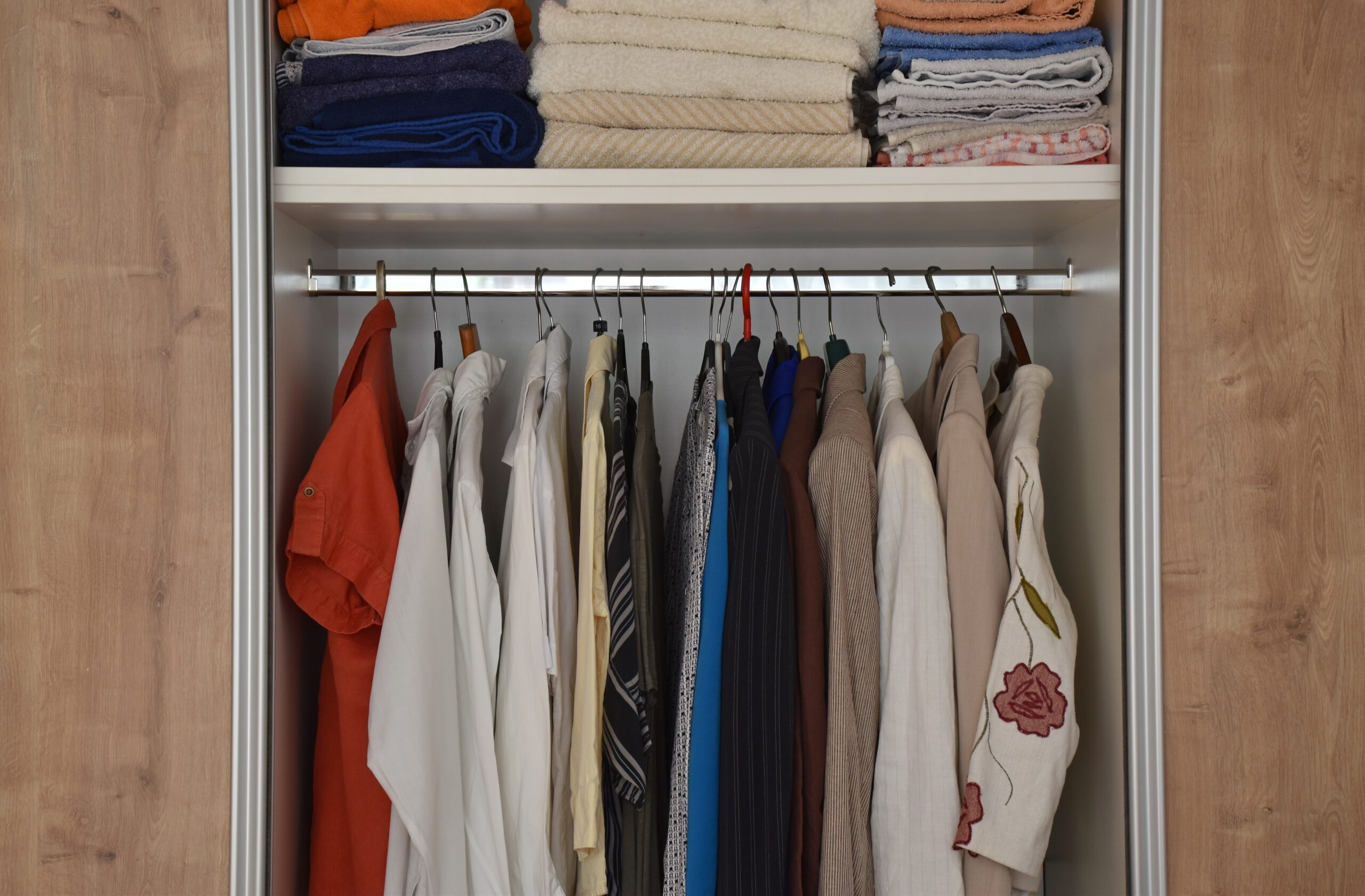 Clothes Moth Control: wardrobe with stored clothing and folded towels